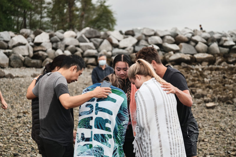 Photo of young adults praying after baptism