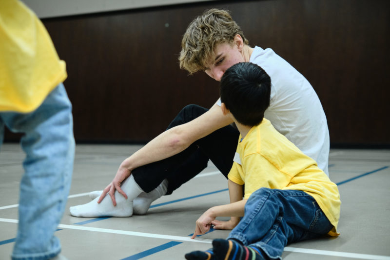 Volunteer sitting with kid