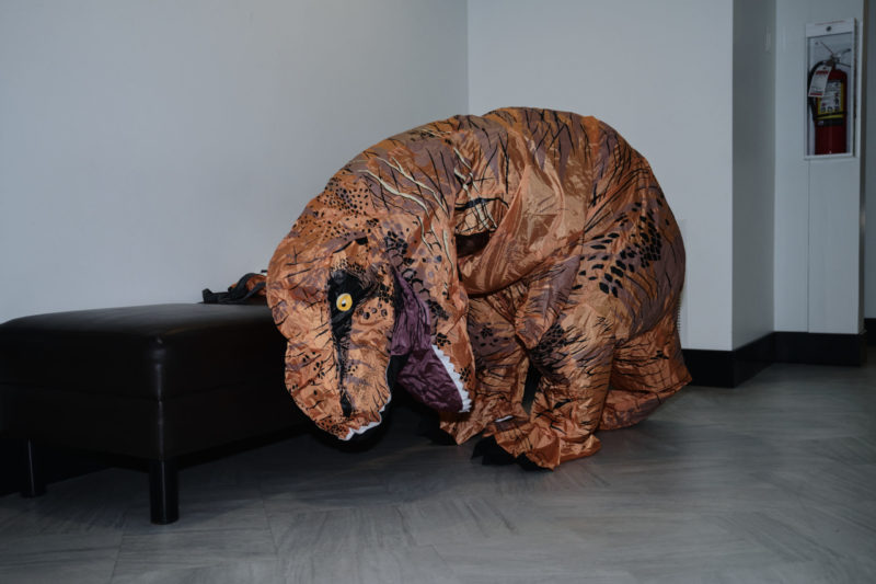 Dinosaur eating couch