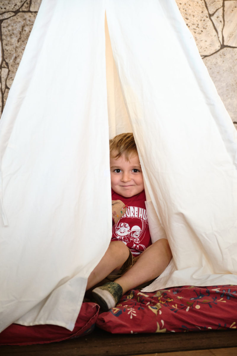 Kid hiding in tent