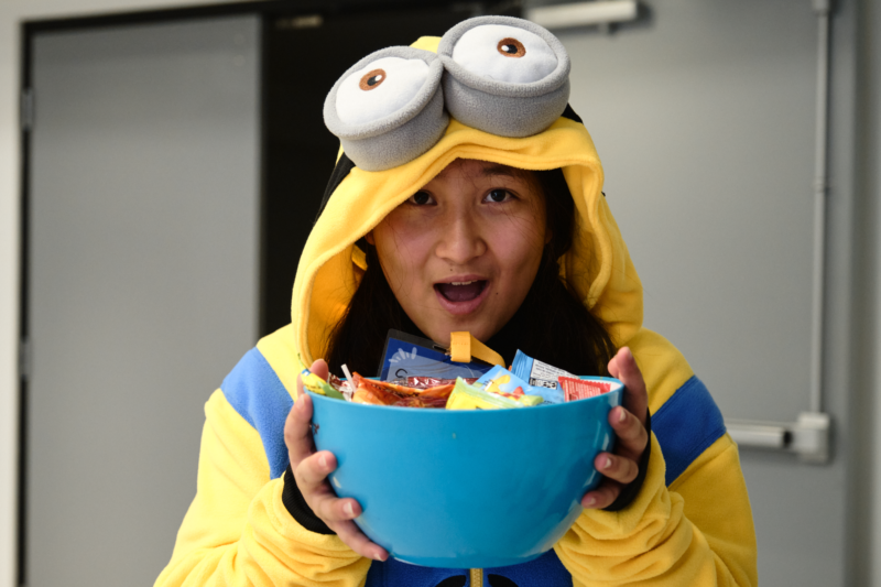 Volunteer holding a bowl of candy